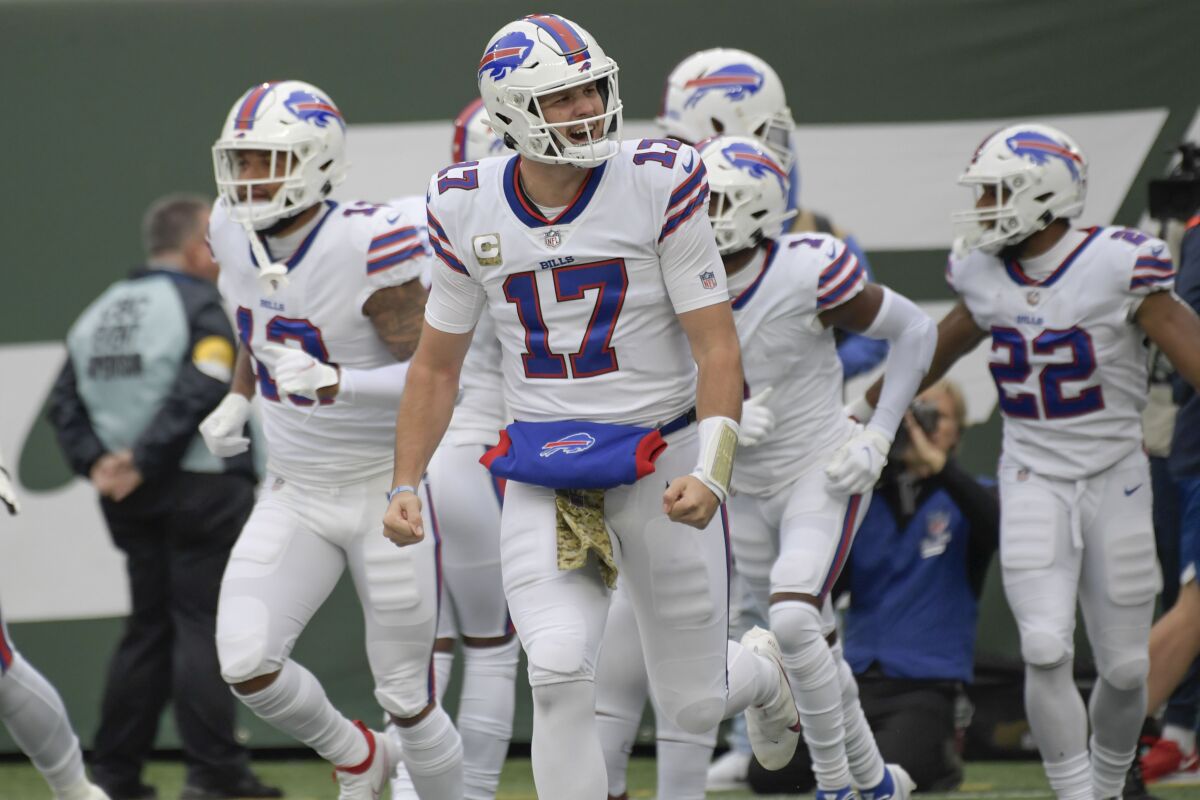 Buffalo Bills quarterback Josh Allen, center, reacts after a touchdown during the first half of an NFL football game against the New York Jets, Sunday, Nov. 14, 2021, in East Rutherford, N.J. (AP Photo/Bill Kostroun)