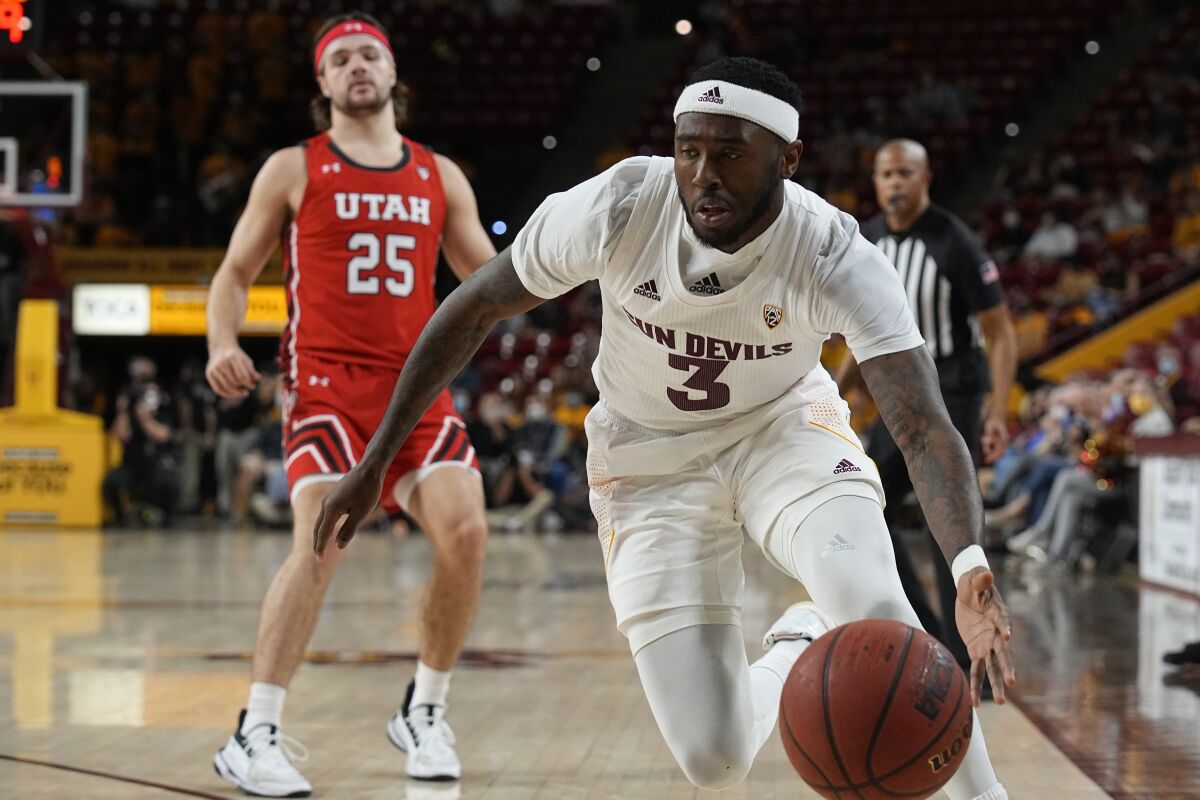 Arizona State guard Marreon Jackson (3) strips the ball from Utah guard Rollie Worster (25) during the first half of an NCAA college basketball game, Monday, Jan. 17, 2022, in Tempe, Ariz. (AP Photo/Rick Scuteri)