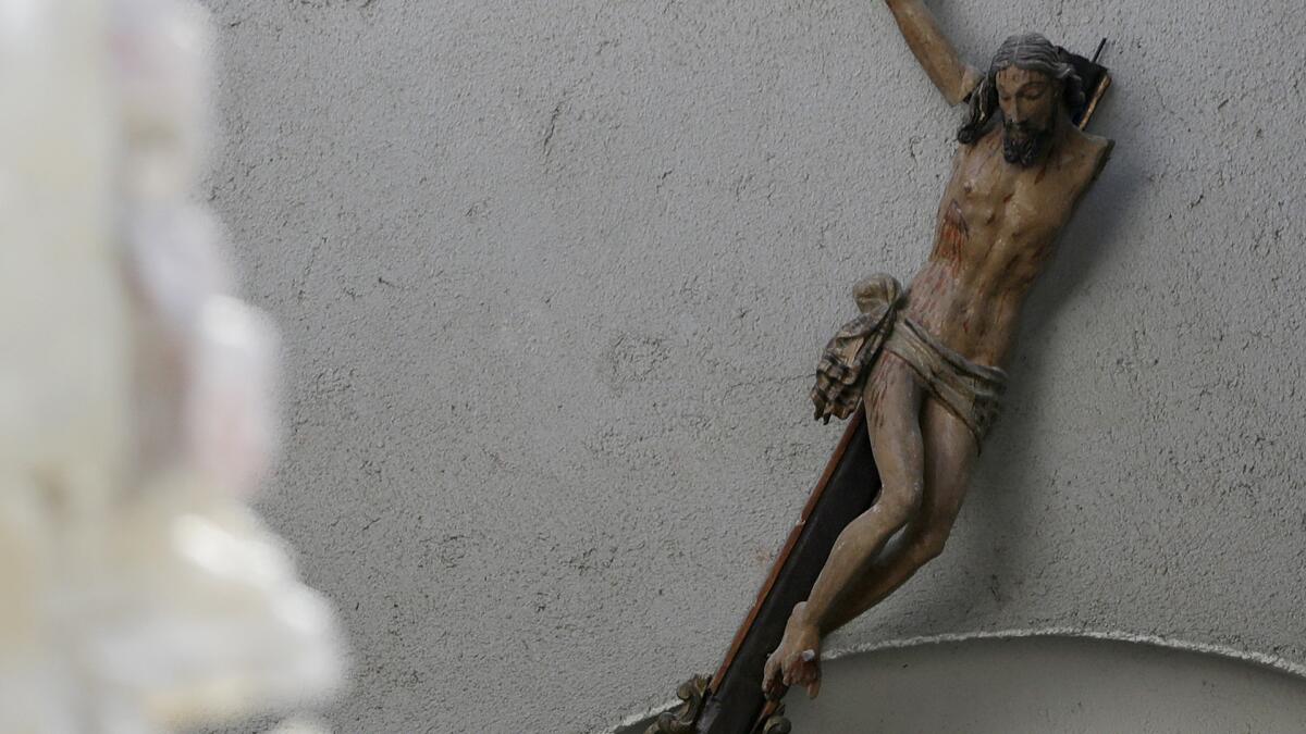 A damaged crucifix is seen inside a church following an earthquake in Accumuli, Italy, on Aug. 26, 2016.