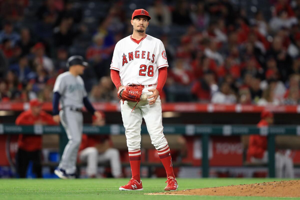 Angels pitcher Andrew Heaney looks on after allowing a three-run home run to Seattle Mariners' Tom Murphy during the sixth inning on Friday at Angel Stadium.