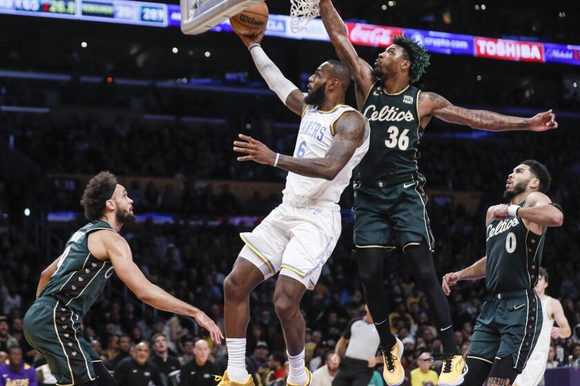 Los Angeles, CA, Tuesday, December 13, 2022 - Los Angeles Lakers forward LeBron James (6) is challenged by Boston Celtics guard Marcus Smart (36) in the first half at Crypto.Com Arena. (Robert Gauthier/Los Angeles Times)