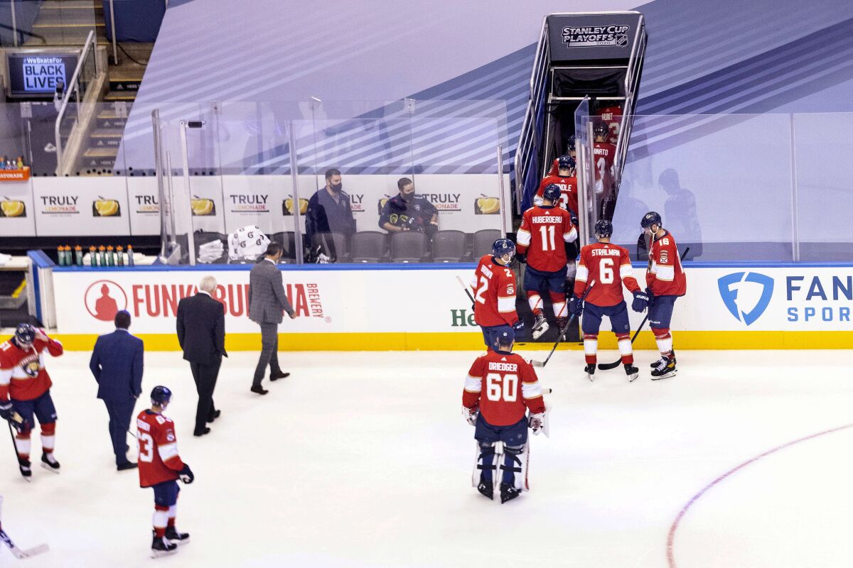 The Florida Panthers skate off the ice after their team's 5-1 loss to the New York Islanders in an NHL Stanley Cup Playoff qualifying round hockey game in Toronto, Friday, Aug. 7, 2020. (Chris Young/The Canadian Press via AP)