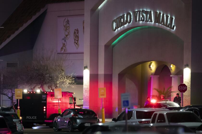 Law enforcement agents are seen at an entrance of a shopping mall, Wednesday, Feb. 15, 2023, in El Paso, Texas. Police say one person was killed and three other people were wounded in a shooting at Cielo Vista Mall. One person has been taken into custody, El Paso police spokesperson Sgt. Robert Gomez said. (AP Photo/Andrés Leighton)