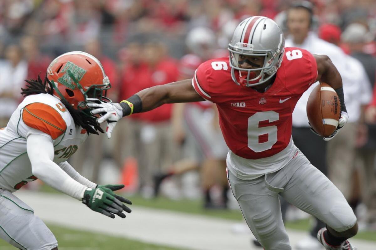 Ohio State wide receiver Evan Spencer avoids a Florida A&M defender during a game Sept. 21.