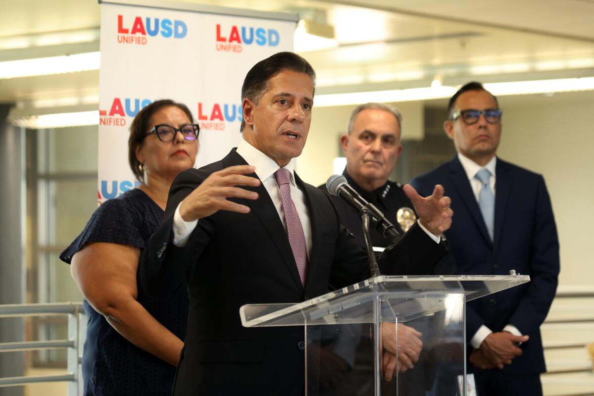Outgoing L.A. Unified board member Monica Garcia stands behind Supt. Alberto Carvalho