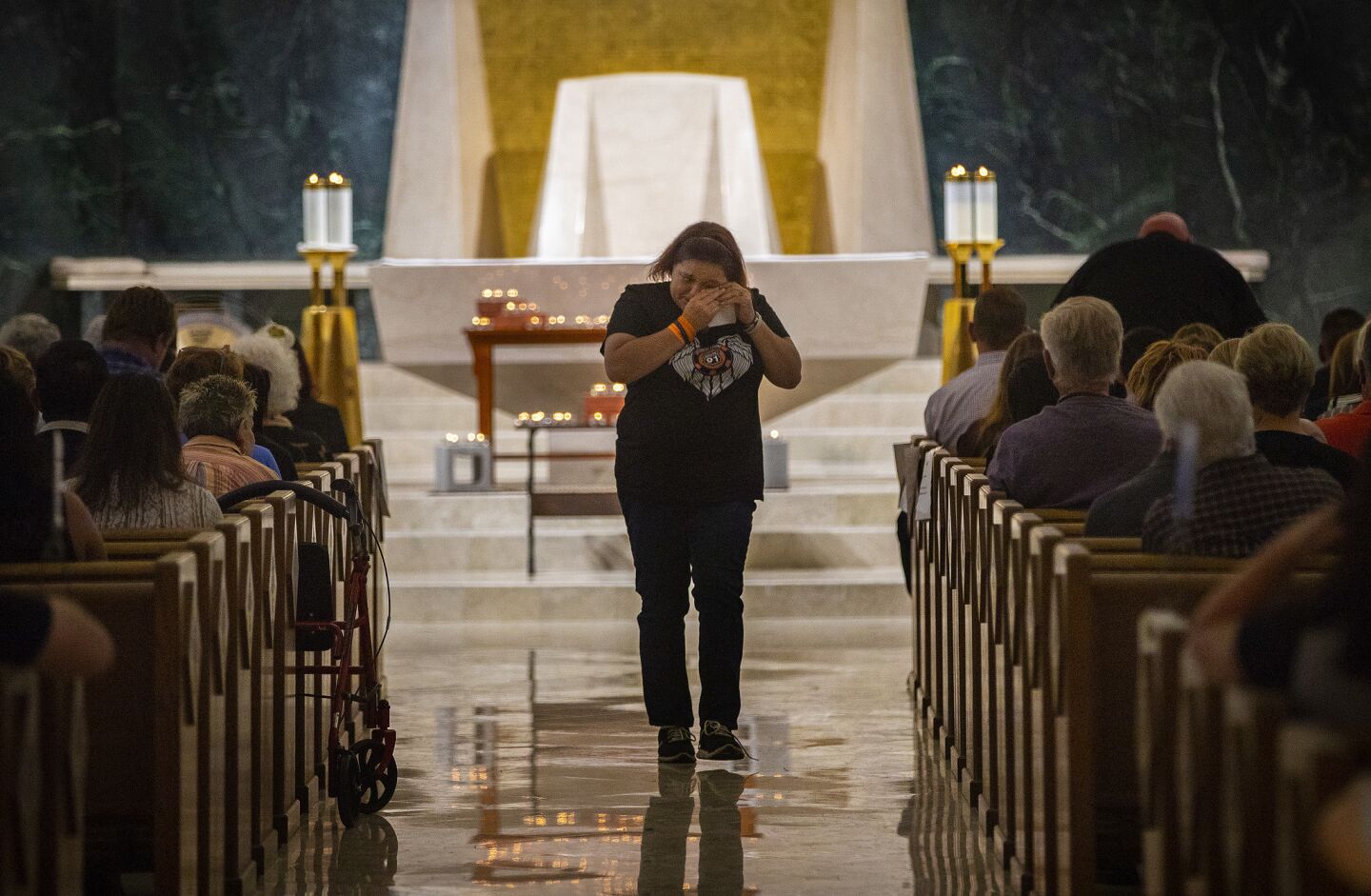 Mindy Scott, a survivor of the 2017 massacre in her hometown of Las Vegas wipes tears after she spoke during an interfaith event at Guardian Angel Cathedral to mark the first anniversary of the mass shooting.