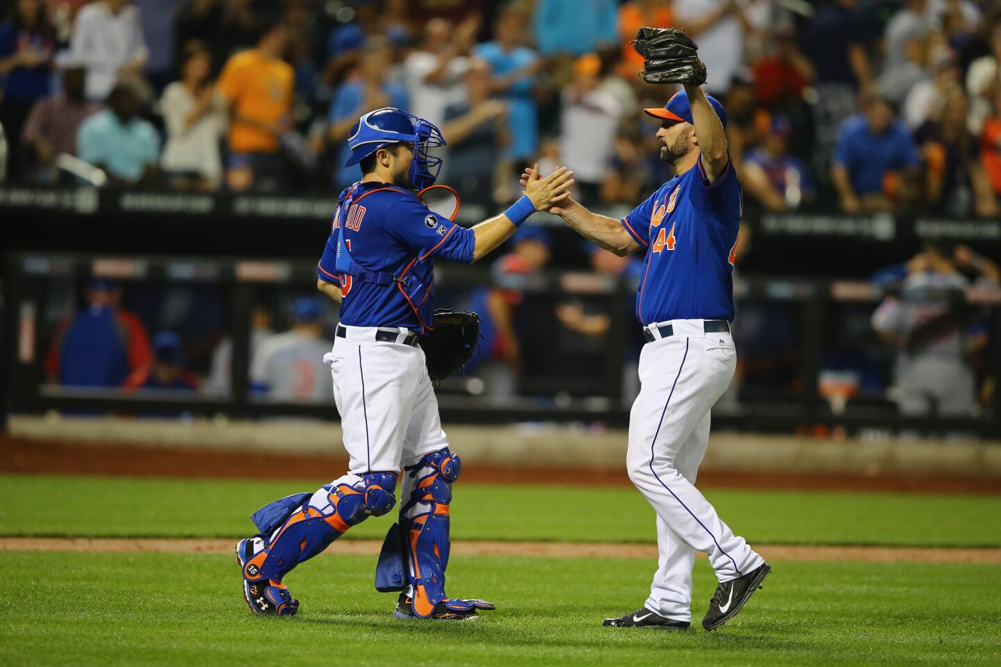 Travis d'Arnaud and Buddy Carlyle celebrate a 7-3 win.