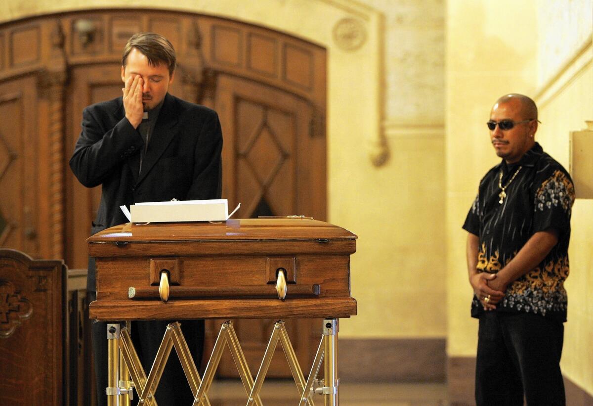 Pallbearers wait with the casket of 23-day-old Luis Angel Garcia in 2007. He was killed when gang members targeted a street vendor.