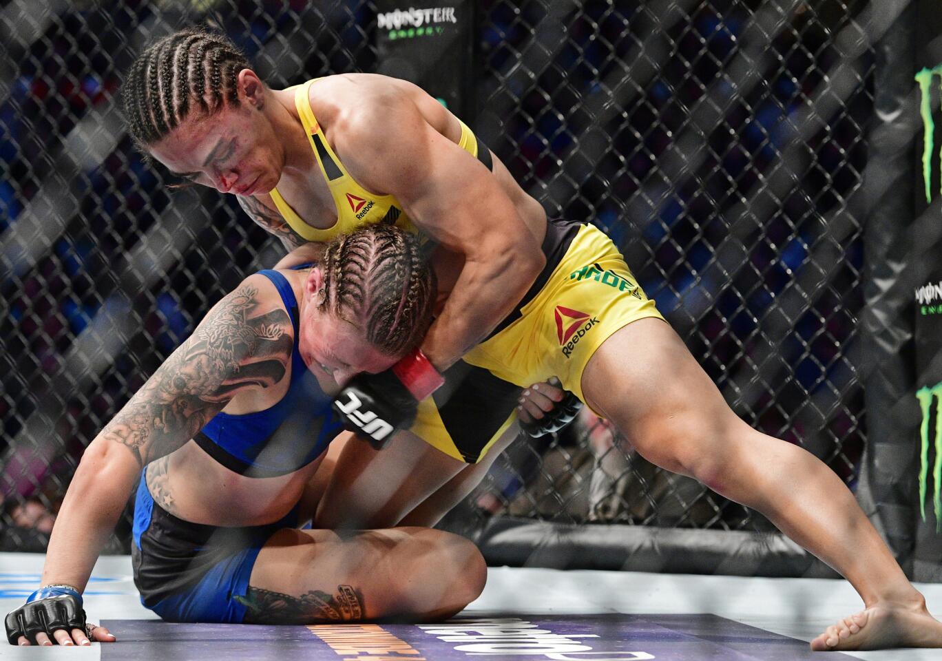Jessica Andrade, top, defeated Joanne Calderwood By submission Sept. 10 at UFC 203 in Cleveland.