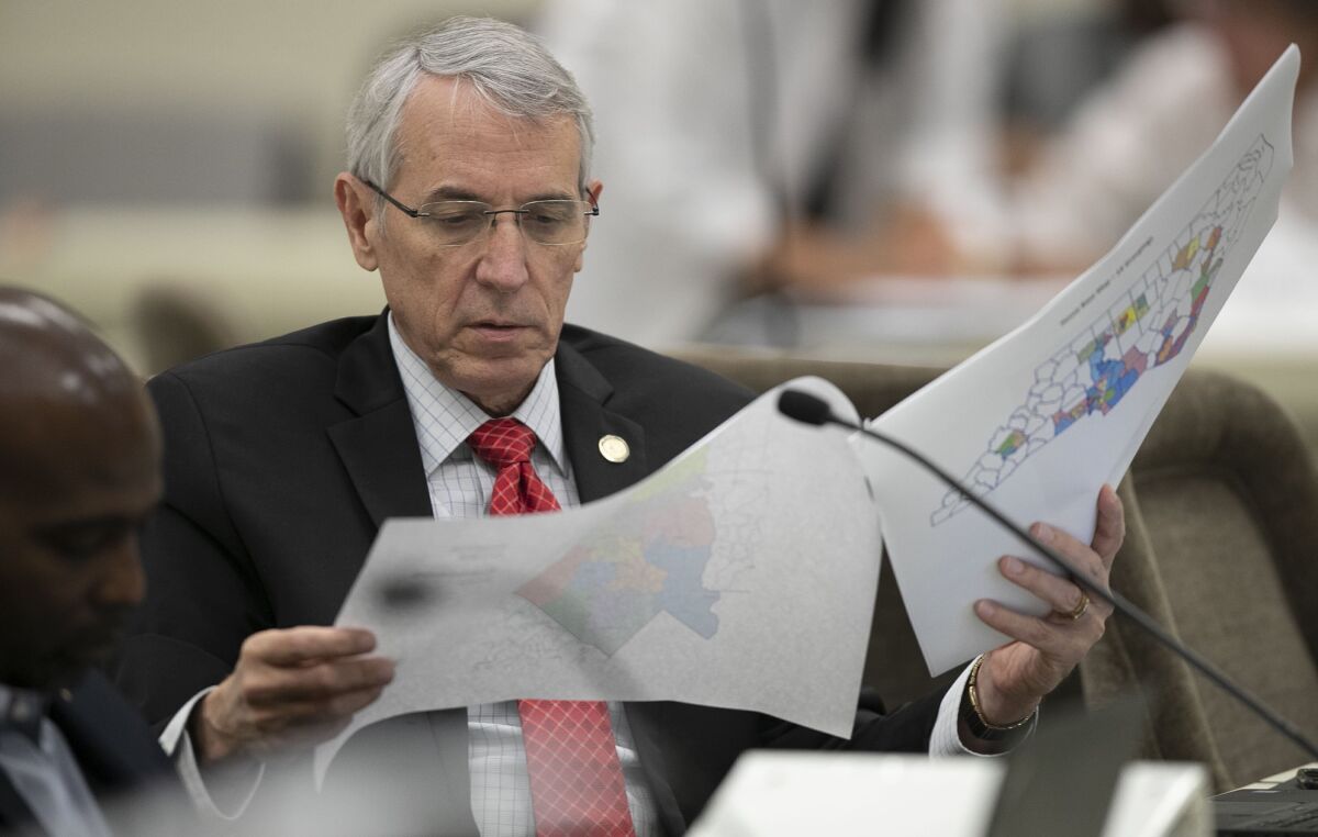 State Rep. John Szoka looks over a redistricting map.