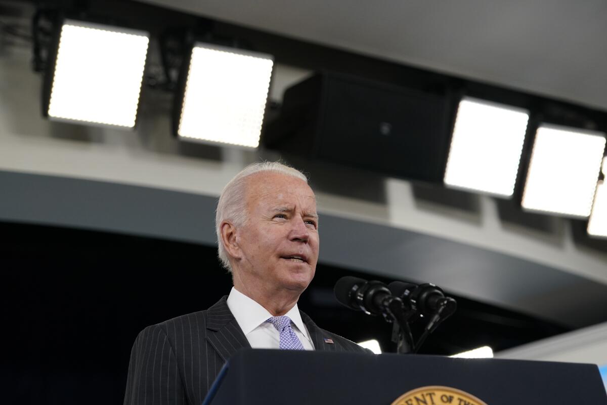 President Biden speaks at a lectern.