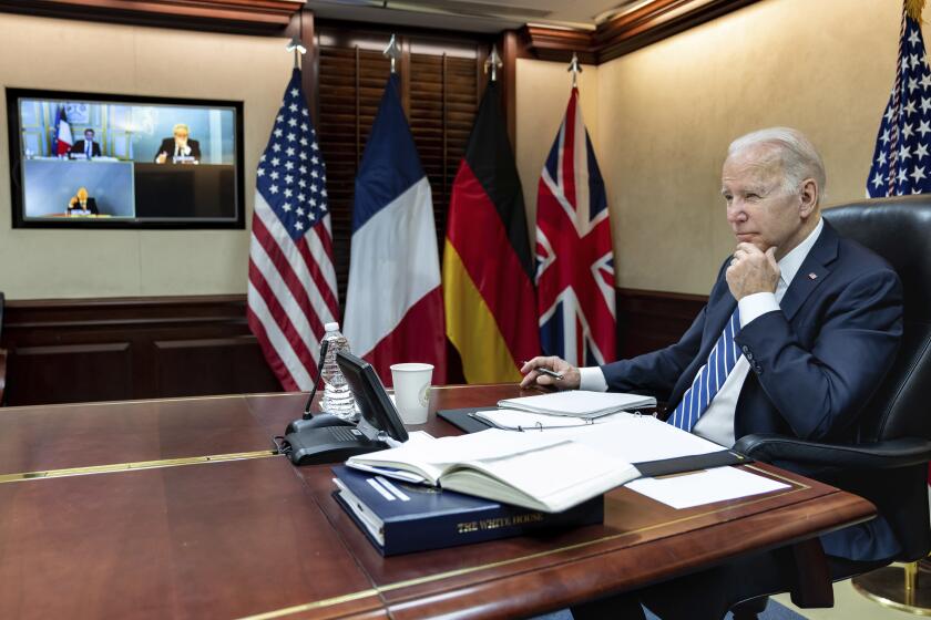 In this image provided by the White House, President Joe Biden listens during a secure video call with French President Emmanuel Macron, German Chancellor Olaf Scholz and British Prime Minister Boris Johnson in the Situation Room at the White House Monday, March 7, 2022, in Washington. (Adam Schultz/The White House via AP)