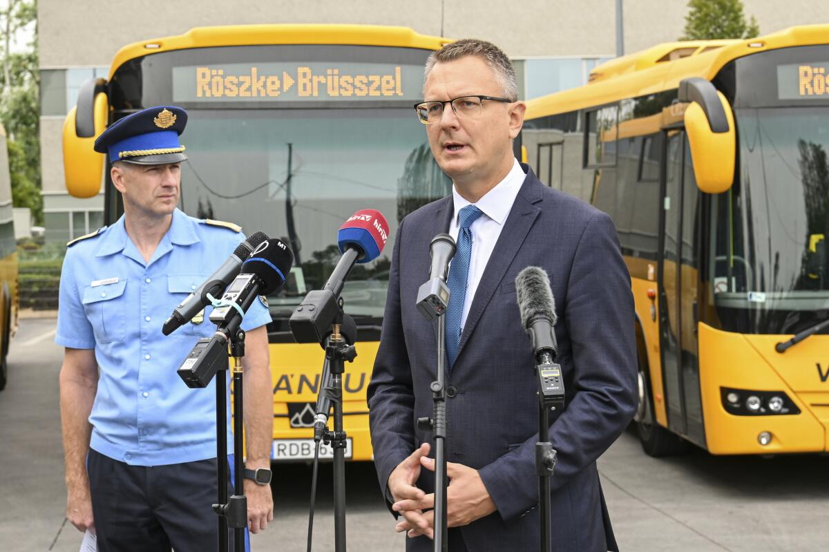 Hungary's State Secretary Bence Rétvári, right, and National Deputy Chief of Police Janos Kuczik hold a joint press.