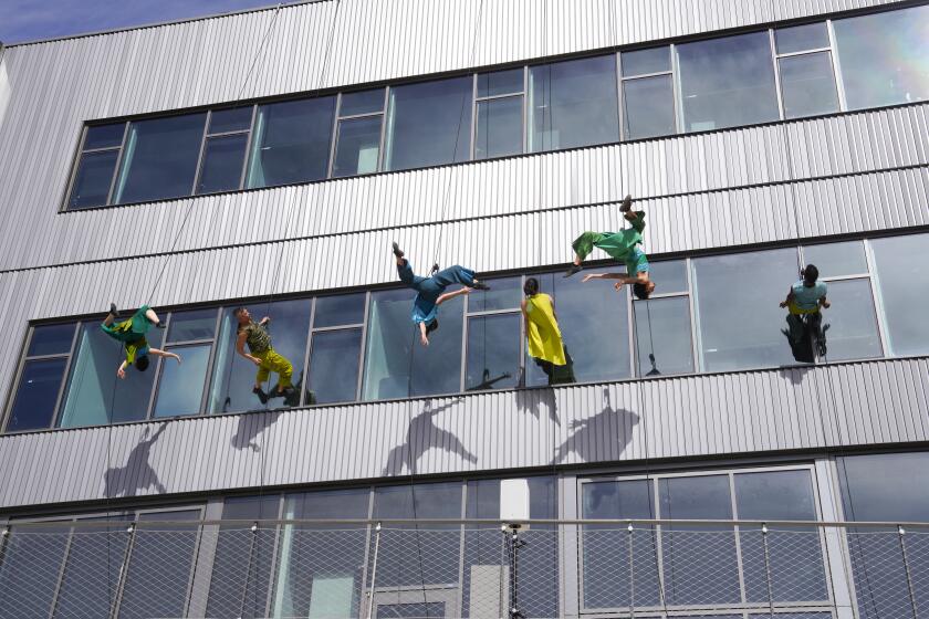 San Diego, CA - April 04: At UC San Diego on Thursday, April 4, 2024, in San Diego, CA, Downstream (tributaries) bv BANDALOOP rehearsed on the walls of the Design and Innovation building for their Friday performance at the La Jolla Playhouse, WOW Festival. The group performs vertical dance work and is directed and conceived by Melecio Estrella and is scheduled to perform on Friday and Saturday at the festival. The festival hours are Thursday and Friday 4pm-9pm, Saturday 11am-9pm, and Sunday 11am-5pm. (Nelvin C. Cepeda / The San Diego Union-Tribune)