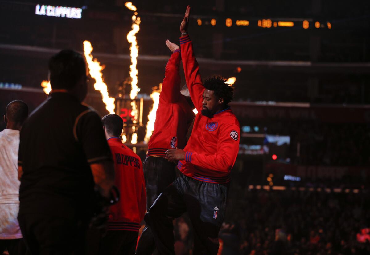 Clippers' DeAndre Jordan and Blake Griffin, left, high-five before a game against the Thunder on Dec. 21.