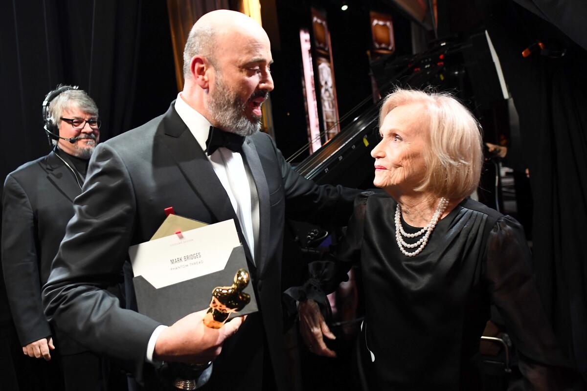 Mark Bridges after his win for costume design with Eva Marie Saint backstage at the 90th Academy Awards.