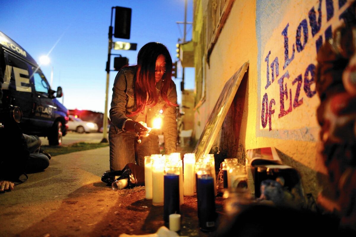Tritobia Ford, mother of Ezell Ford, lights candles at her slain son's memorial at 65th Street and Broadway.