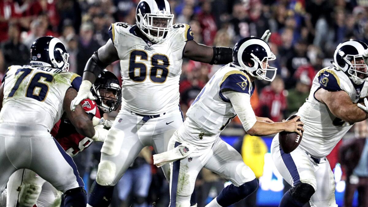 Rams quarterback Jared Goff scrambles away from pressure during the fourth quarter of the playoff game against the Falcons.