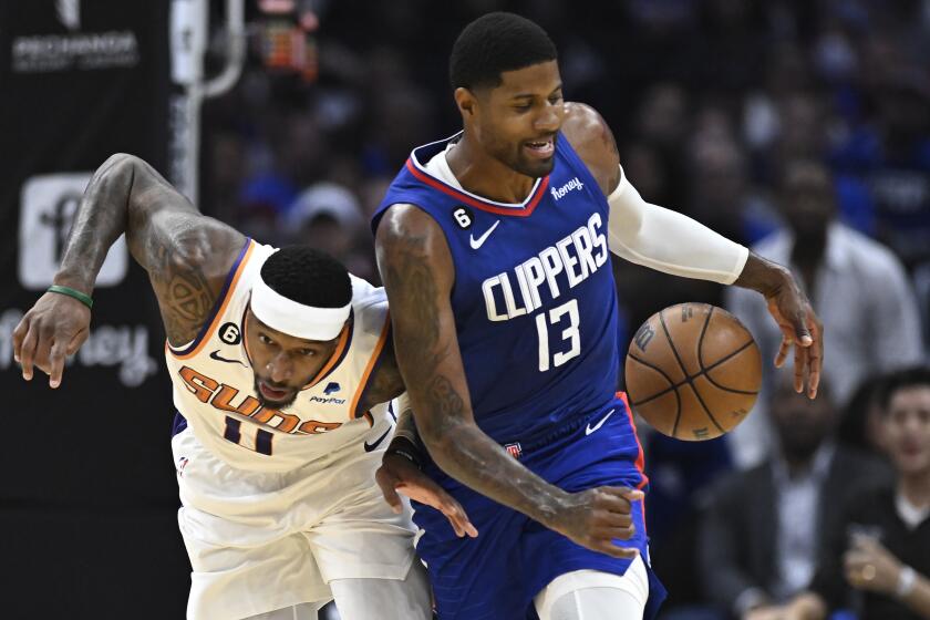 Phoenix Suns center Jock Landale, left, bumps into Los Angeles Clippers guard Paul George.