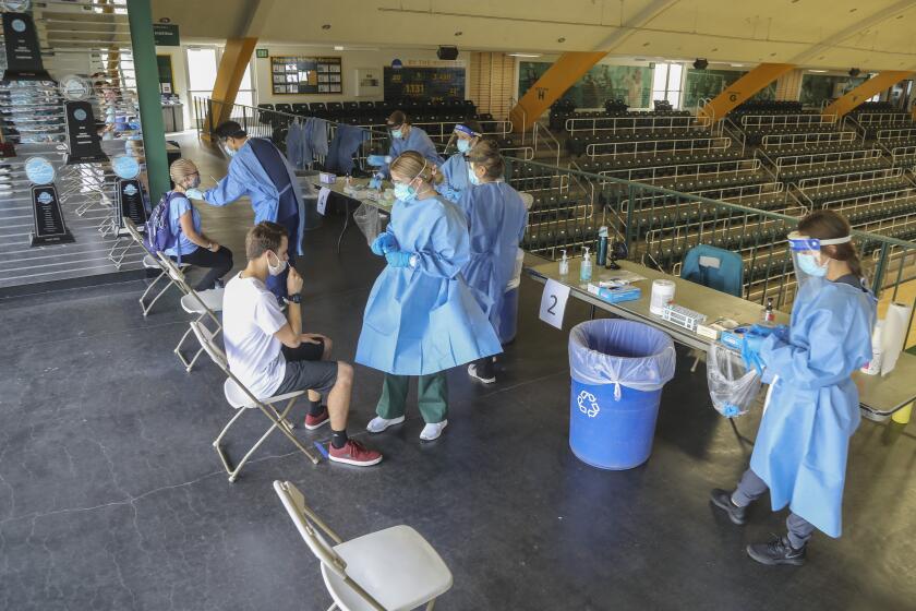 SAN DIEGO, CA - OCTOBER 15: Nursing students administer Covid tests to students in the gymnasium at Point Loma Nazarene University on Thursday, Oct. 15, 2020 in San Diego, CA. (Eduardo Contreras / The San Diego Union-Tribune)