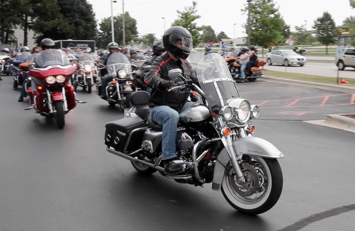 Wisconsin Gov. Scott Walker rides his Harley-Davidson during a leg of Ride with Walker on July 26 in Sheboygan, Wis. The Wisconsin Supreme Court handed the governor two victories on Thursday in backing his labor law and a voter identification law.