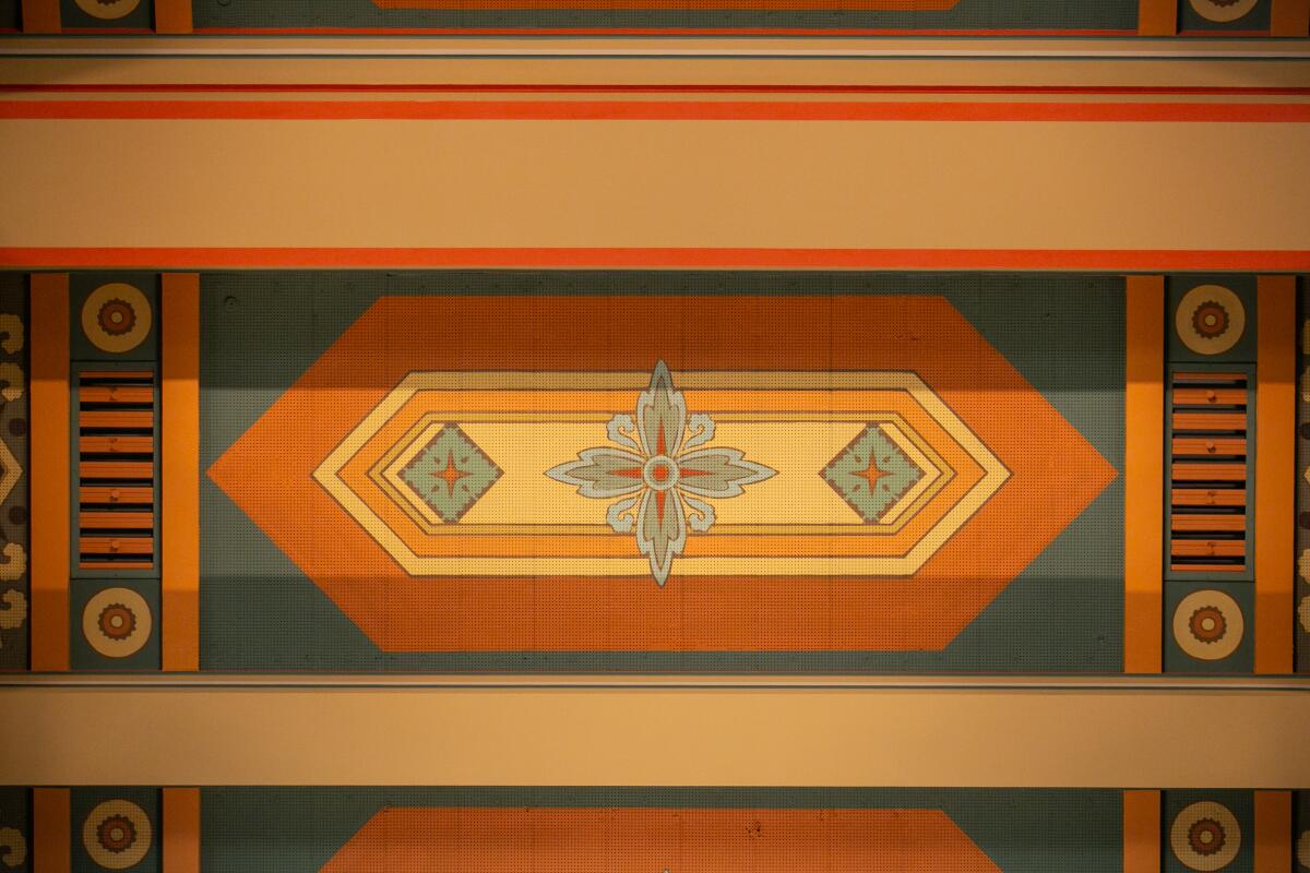 The ceiling at Union Station reveals bright geometric and floral patterns in earthy hues of orange, green and yellow.