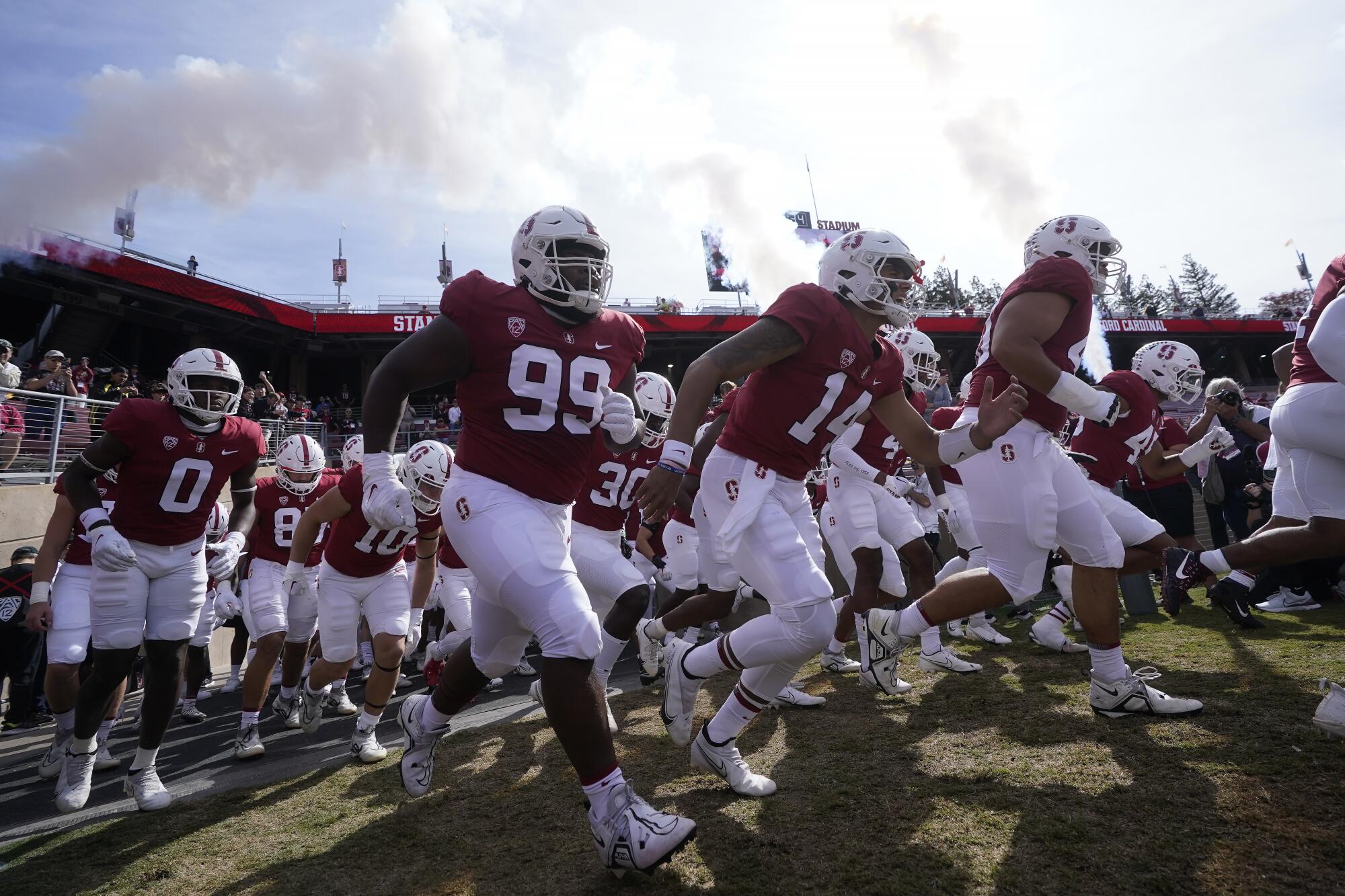 Stanford players run onto the field before an NCAA college football game against Arizona State.