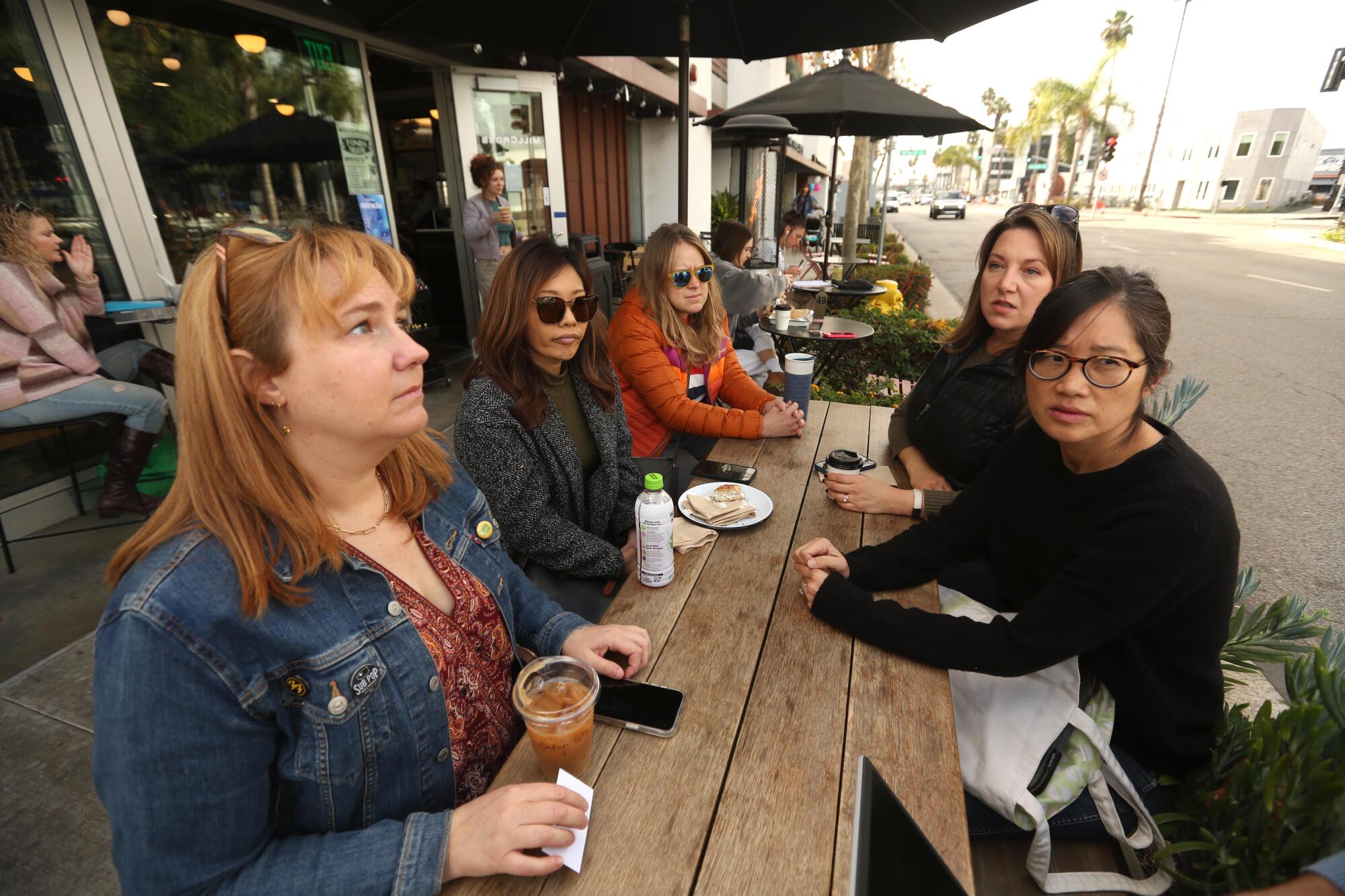 Members of Culver 878 sit at a coffee shop within view of the Martin B. Retting gun store in Culver City.