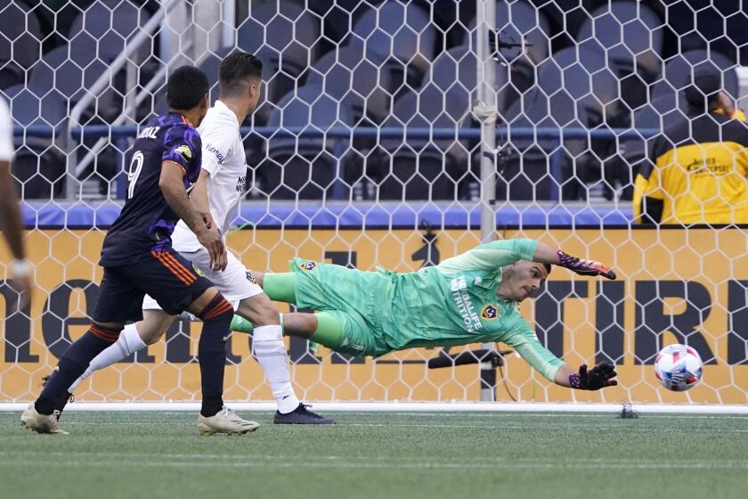 Los Angeles Galaxy goalkeeper Jonathan Bond dives but can't stop a goal kicked by Seattle Sounders forward Raul Ruidiaz.