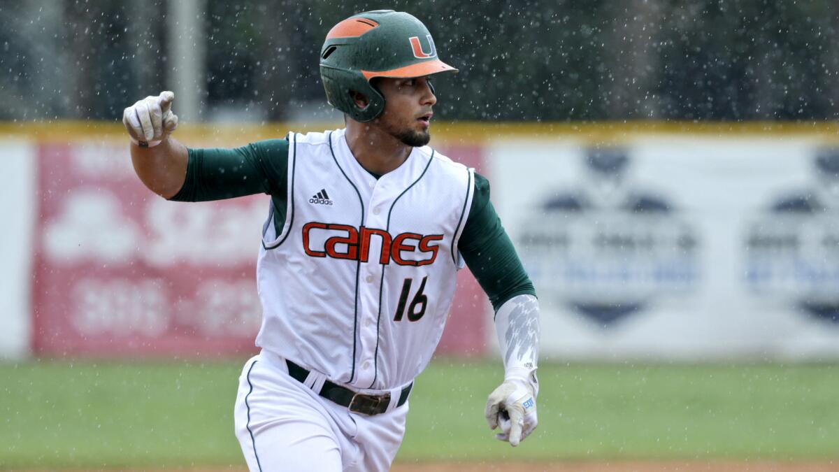 Miami's Edgar Michelangeli celebrates as he rounds third base after hitting a grand slam against Boston College in the seventh inning Sunday.