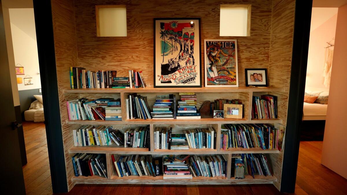 VENICE, CA - NOVEMBER 1, 2016 - A bookshelf made of plywood rests between bedrooms on the second floor of the home of Paul Hibler and his wife Tiffany Rochelle in Venice on November 1, 2016. (Genaro Molina / Los Angeles Times)