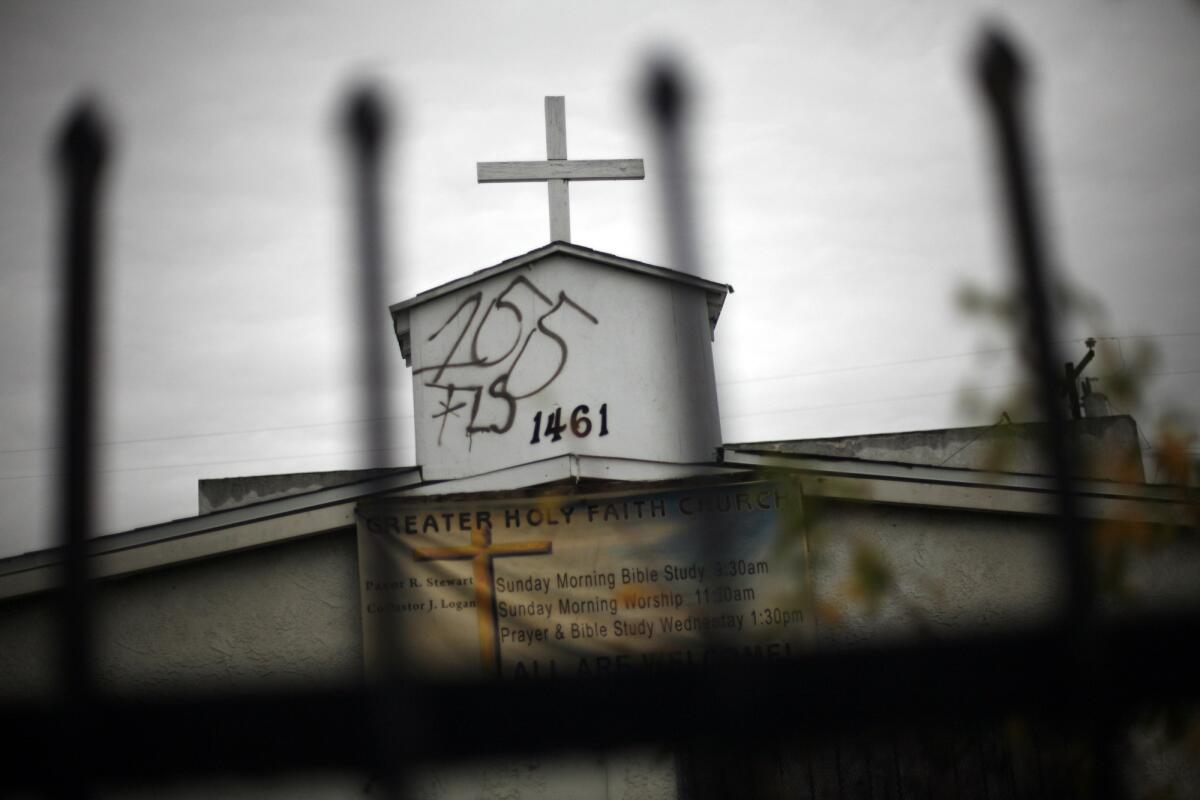 Graffiti marred the steeple on the Greater Holy Faith Baptist Church on 155th Street in Compton in January. Two members of 155th Street Gang were charged with federal hate crimes.