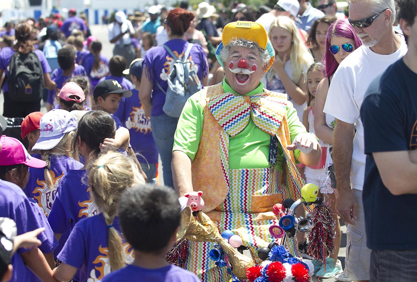 Ravioli the clown greets kids from a Westminster summer camp as they get in line to attend the OC Fair on Thursday.