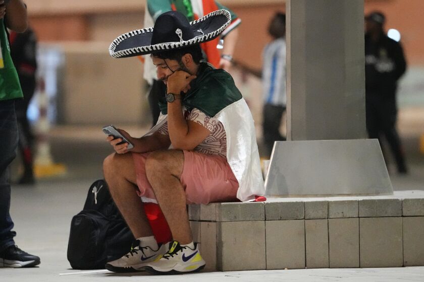A Mexico supporter sits outside Lusail Stadium following following Argentina's 2-0 victory over Mexico in a World Cup group C soccer match in Lusail, Qatar, Suday, Nov. 27, 2022. (AP Photo/Julio Cortez)