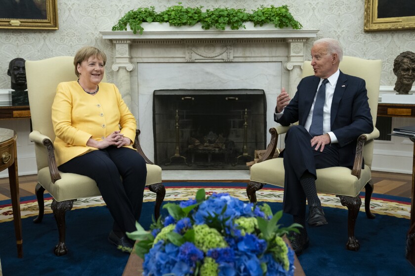 President Joe Biden meets with German Chancellor Angela Merkel in the Oval Office of the White House, Thursday, July 15, 2021, in Washington. (AP Photo/Evan Vucci)
