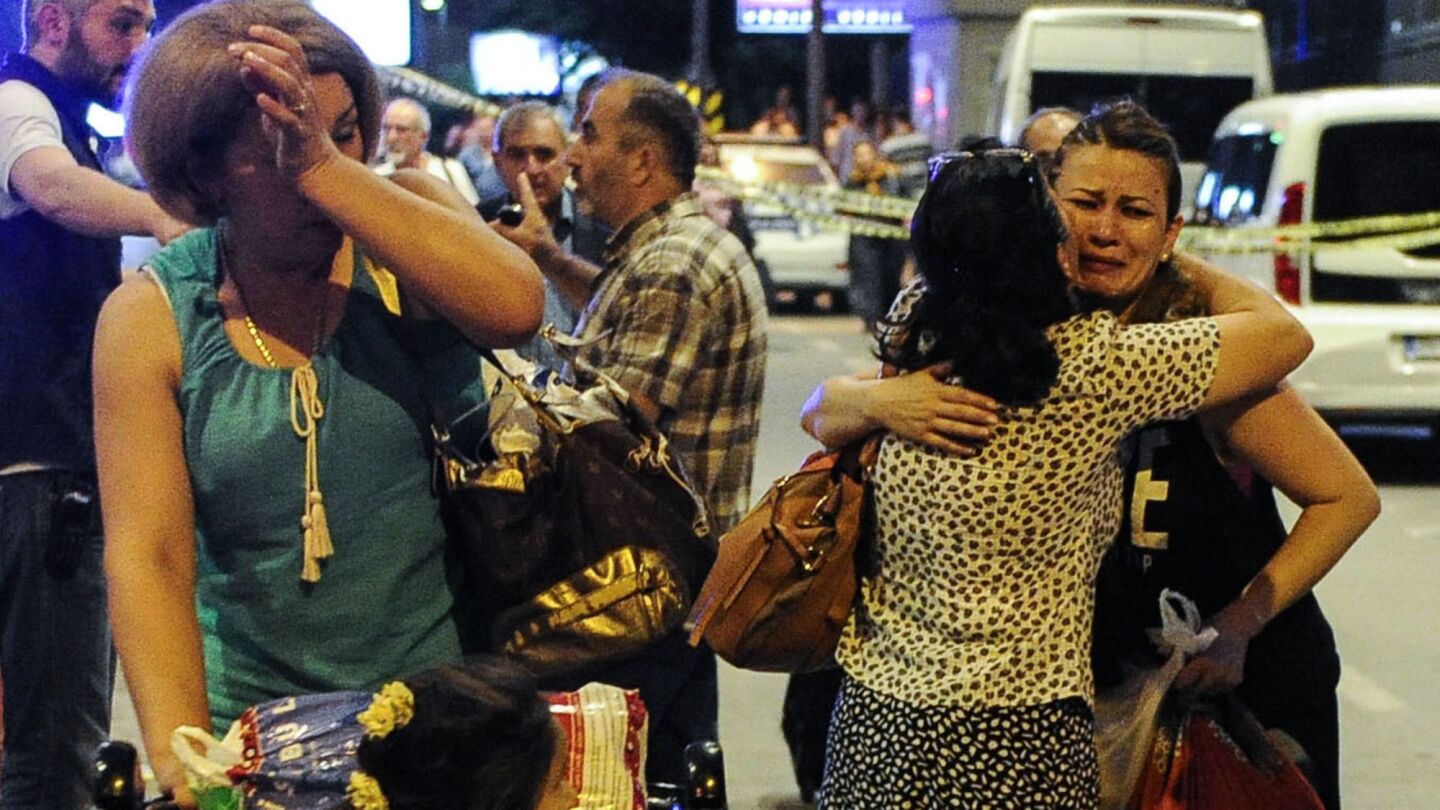 Travelers who survived from the suicide bomb attack cry as they leave the Turkey's largest airport, Istanbul Ataturk, on Tuesday.