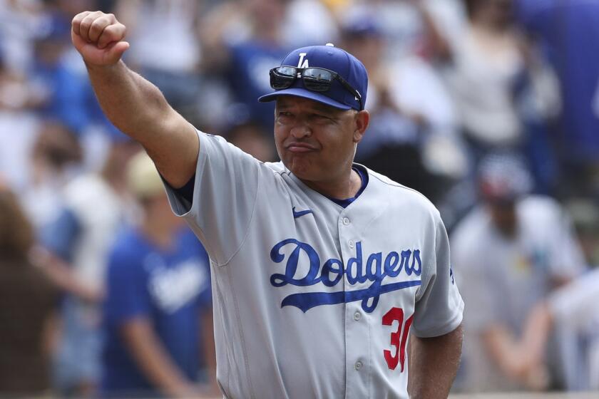 Los Angeles Dodgers manager Dave Roberts gestures to the crowd after the team.