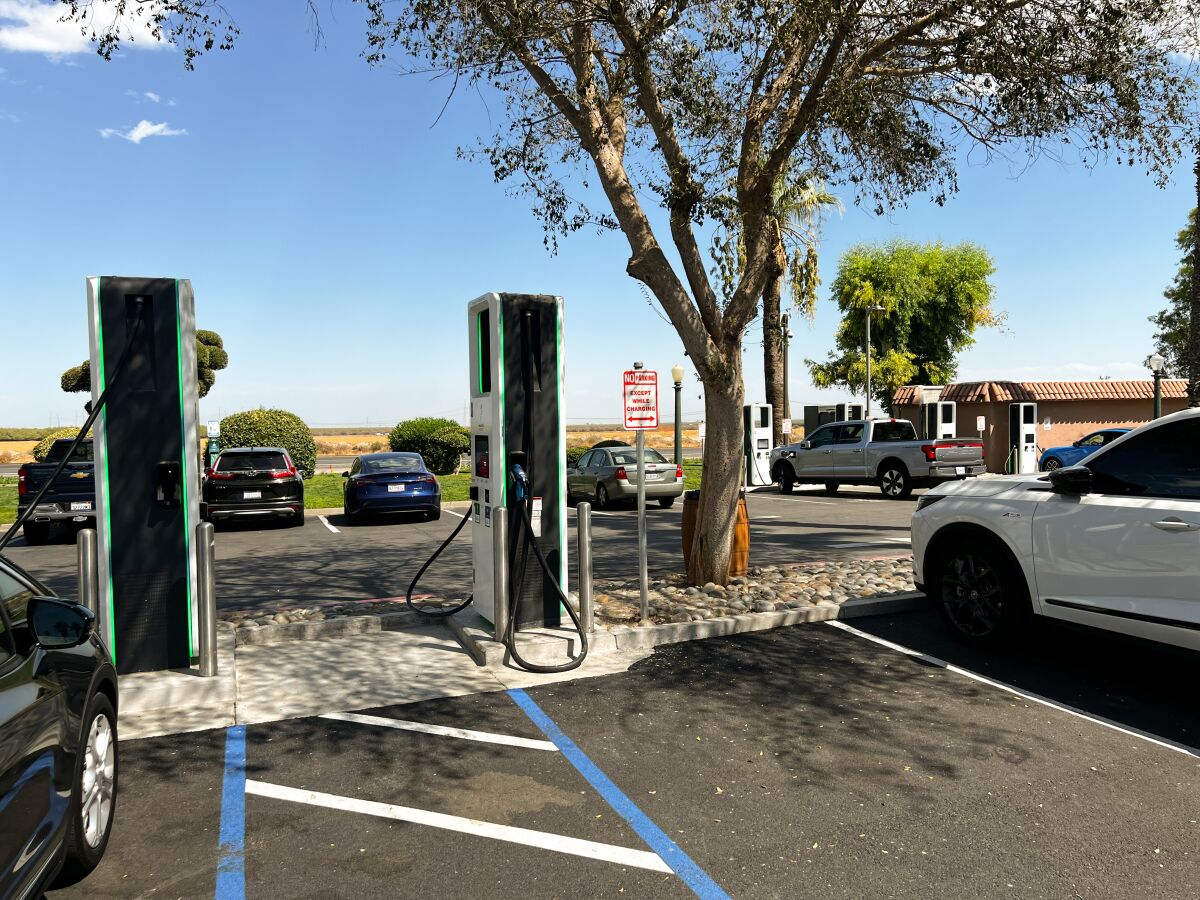 Electric vehicle charging stations in a parking lot.