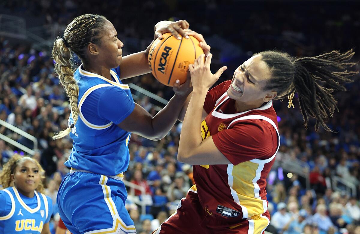 UCLA's Charisma Osborne, left, battles USC's McKenzie Forbes for the ball at Pauley Pavilion.
