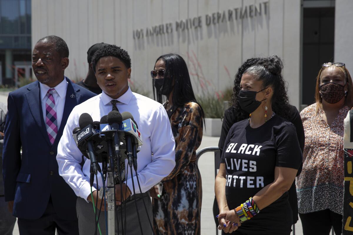 Jamal Shakir, center, flanked by his attorney and the BLM-LA cofounder