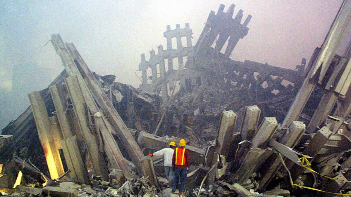 Rescue workers survey the ruins of the World Trade Center in New York in 2001.