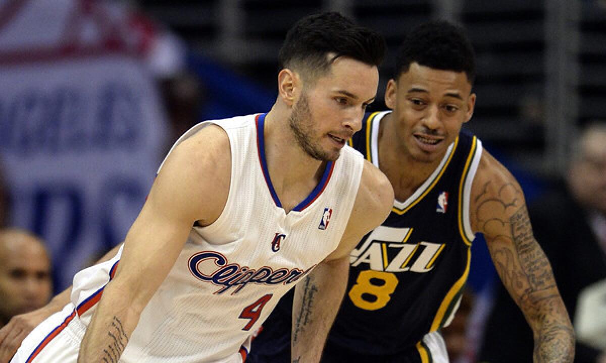Clippers guard J.J. Redick, left, tries to drive past Utah Jazz point guard Diante Garrett during a game on Feb. 1. Redick has missed the last 17 games because of a back injury.