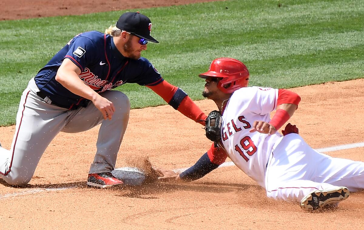 Angels' Juan Lagares is tagged out by Minnesota Twins third baseman Josh Donaldson while trying to steal third base.