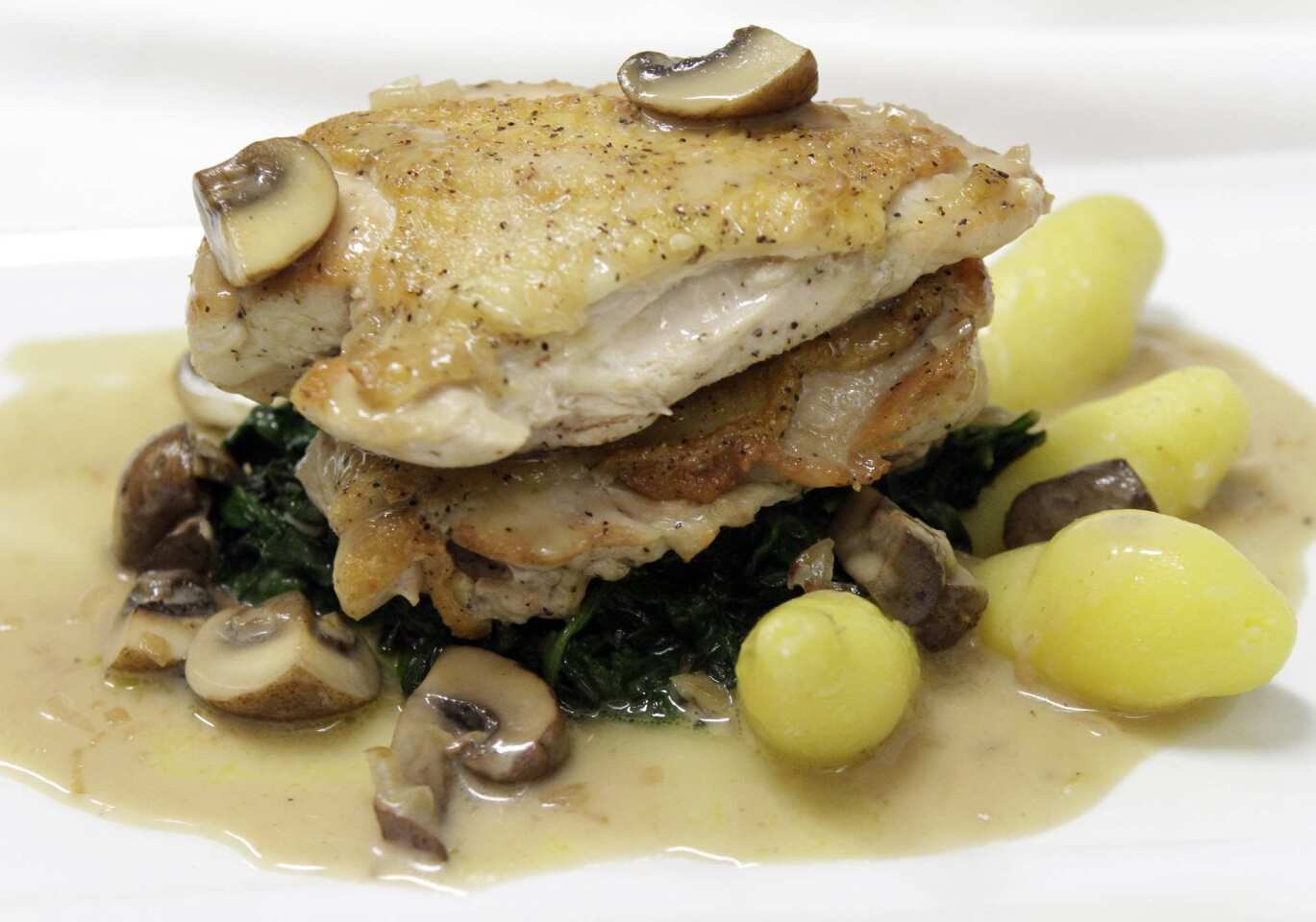 Pan-roasted chicken comes with Marsala sauce, sauteed garlic spinach, mushrooms and fingerling potatoes.