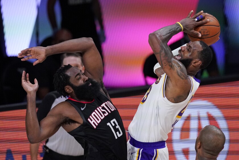 Lakers' LeBron James shoots over Houston Rockets' James Harden.