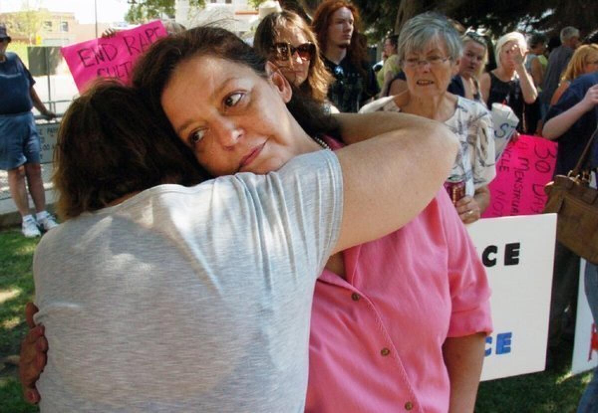 Auliea Hanlon receives a hug from a supporter during a rally in Billings, Mont., calling for the resignation of a judge who gave a light sentence to the rapist of Hanlon's daughter.