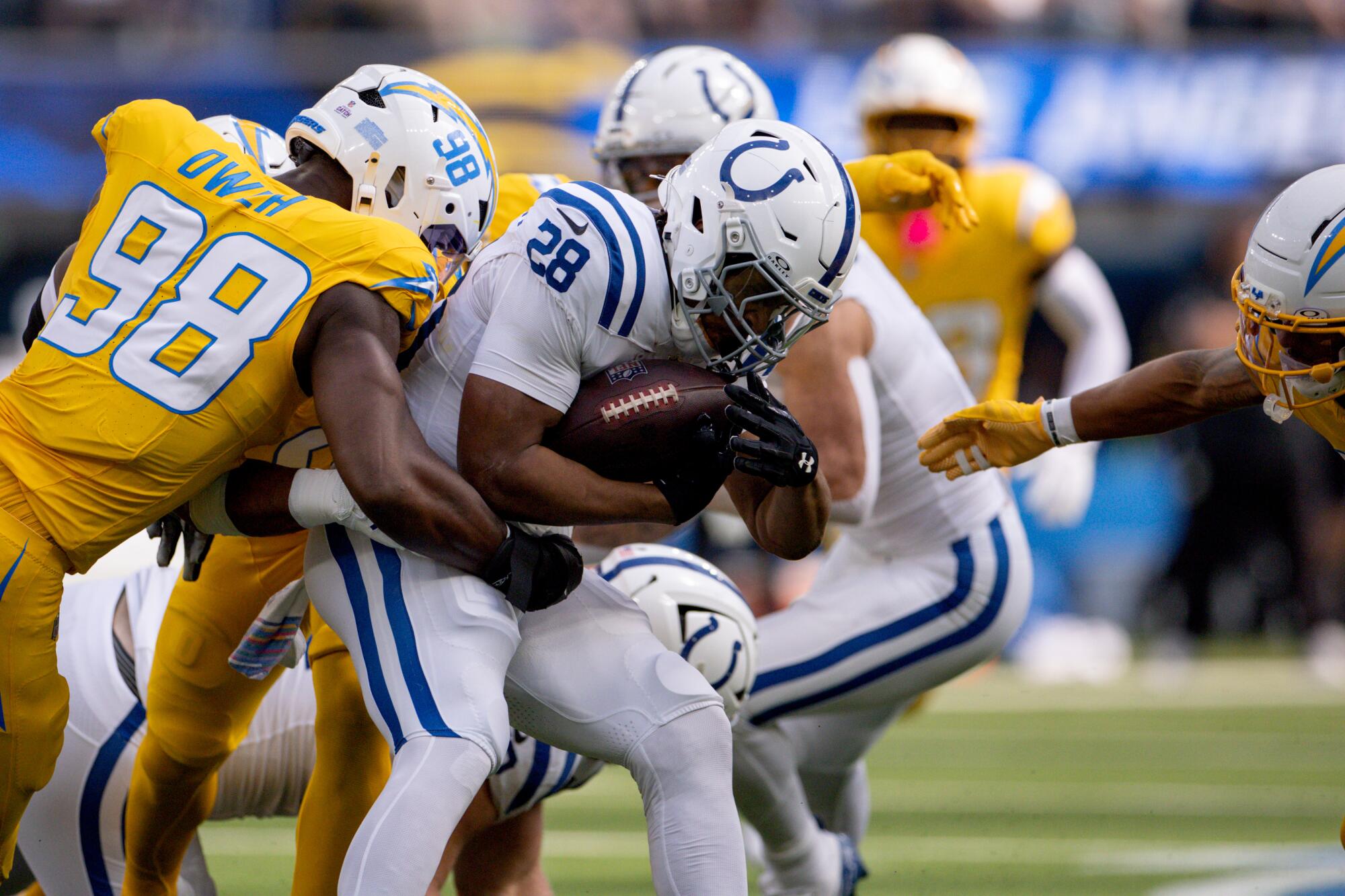 Indianapolis Colts running back Jonathan Taylor is hit by Chargers linebacker Odafe Oweh.