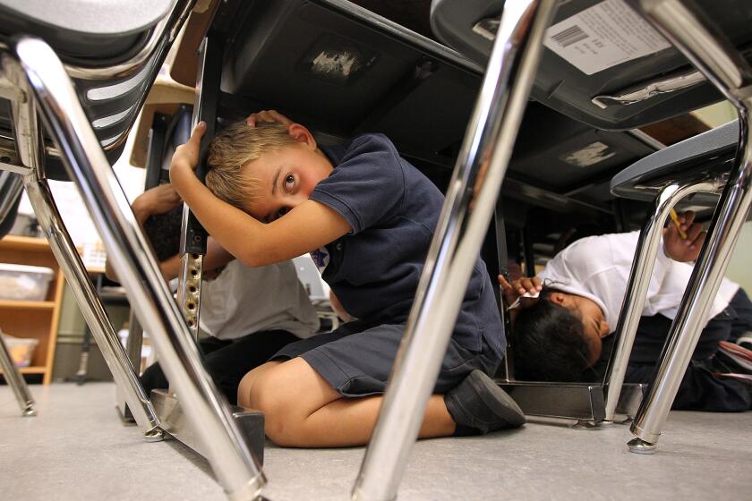 Third-grade students take cover under desks as they participate in the "Great California ShakeOut" earthquake drill in 2011 in San Francisco. On Tuesday, San Francisco supervisors approved a law requiring private schools to be seismically evaluated.