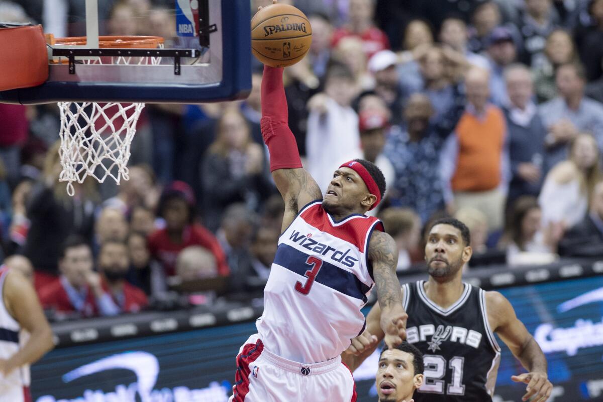 Wizards guard Bradley Beal (3) goes up for a dunk in front of Spurs center Tim Duncan (21) during the second half.