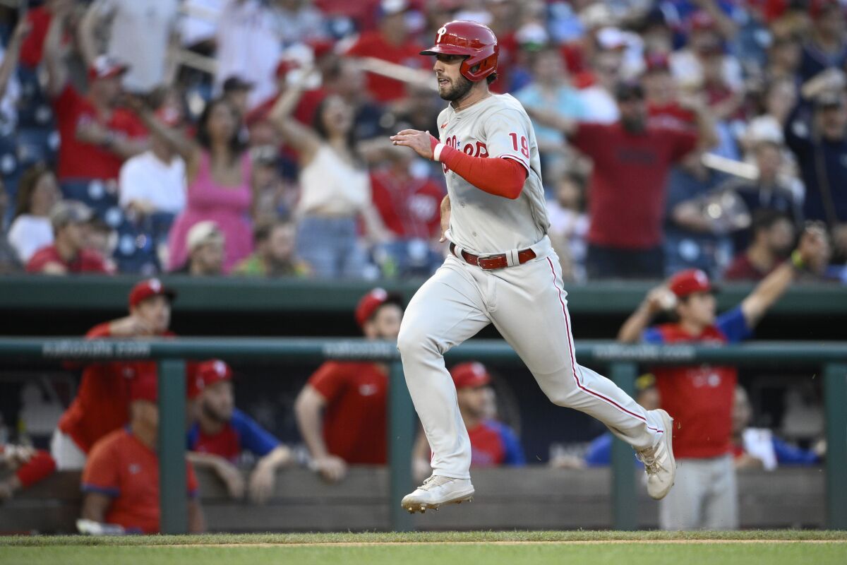 Philadelphia Phillies' Matt Vierling runs toward home to score on a single by Rhys Hoskins during the 10th inning of the team's baseball game against the Washington Nationals, Saturday, June 18, 2022, in Washington. The Phillies won 2-1 in 10 innings. (AP Photo/Nick Wass)